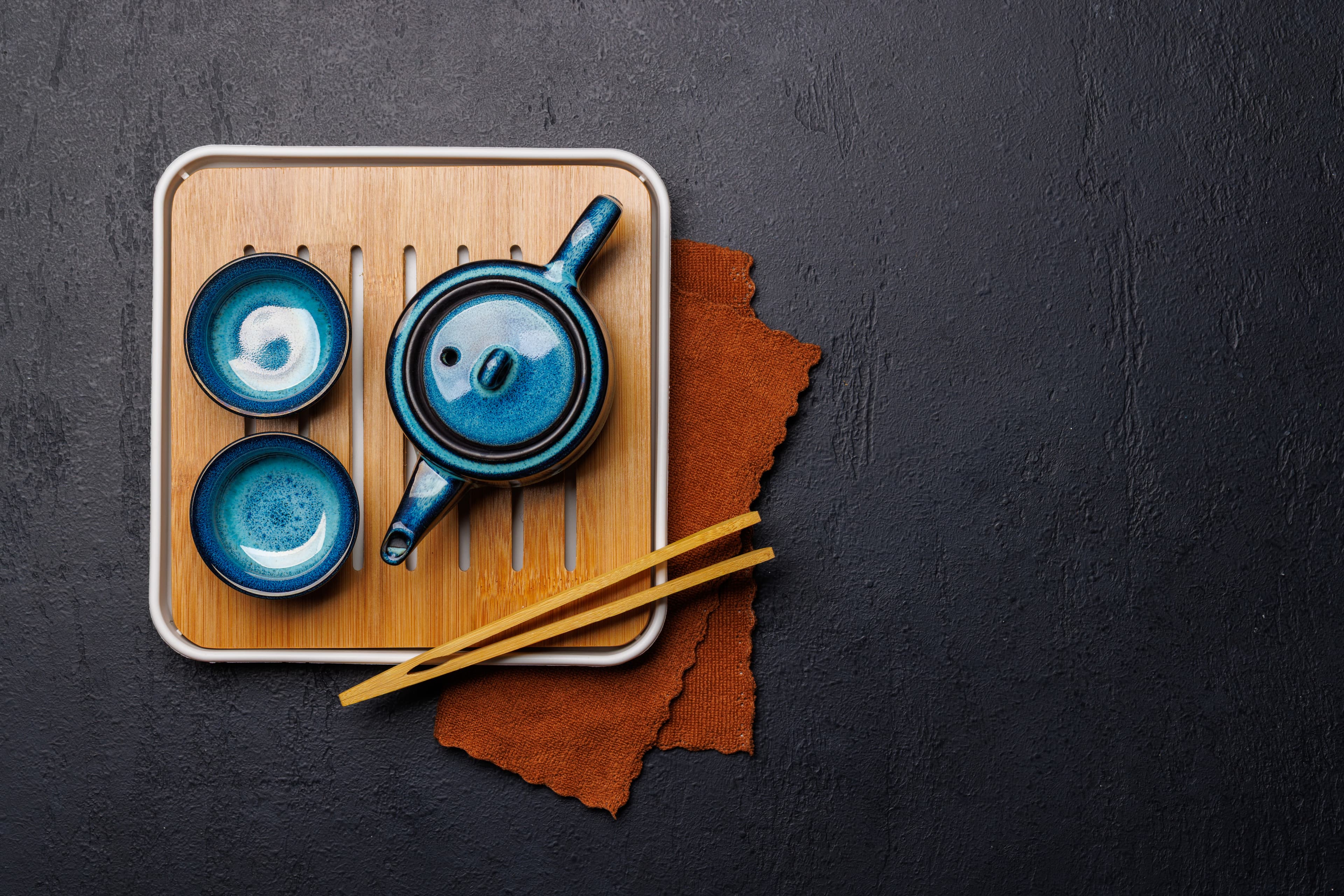Blue ceramic travel tea kit on a tray