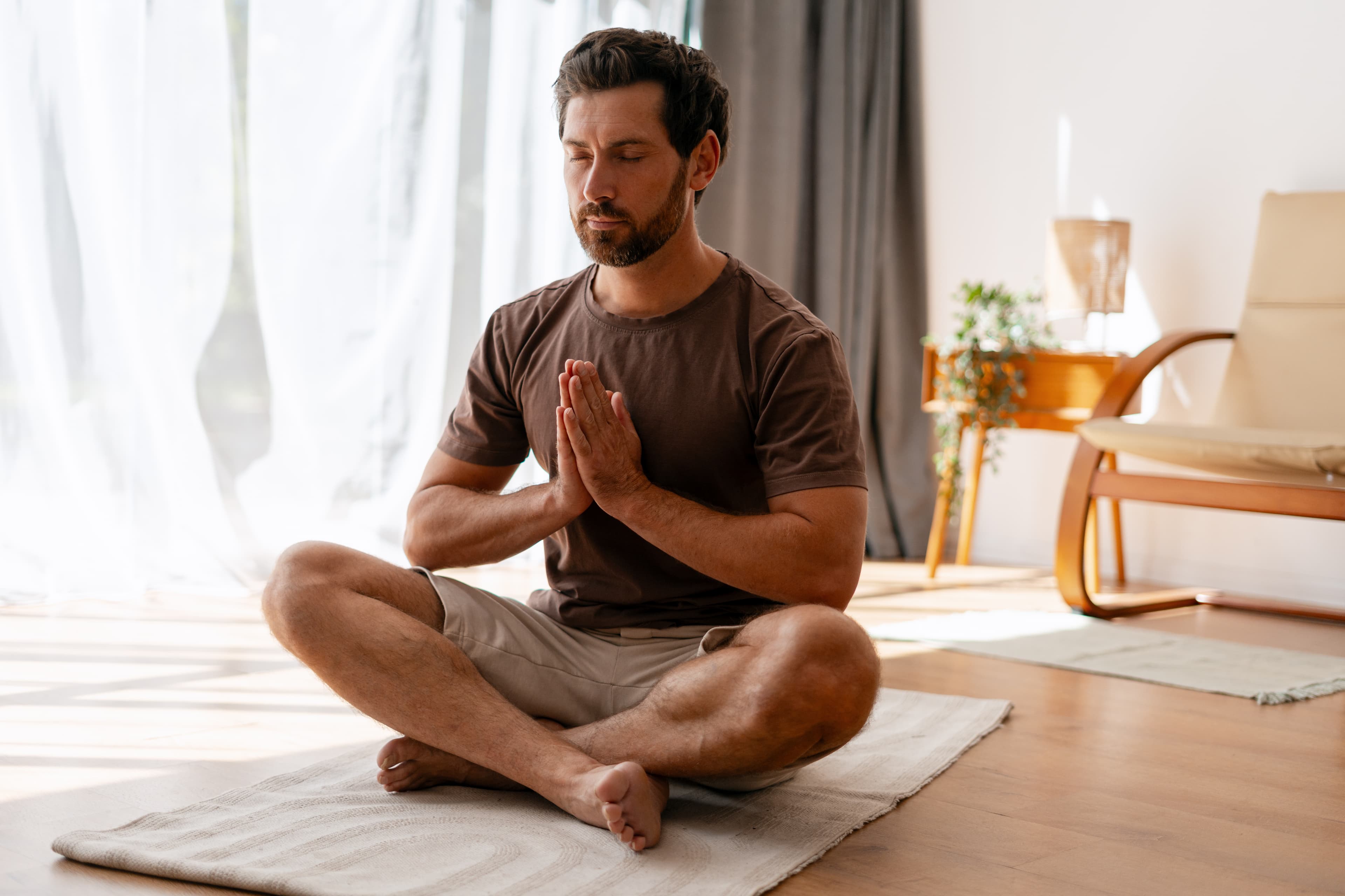 Man practicing mindfulness meditation at home